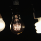 A CFL bulb (right), a vintage-style incandescent bulb (center), and an LED bulb (left).
